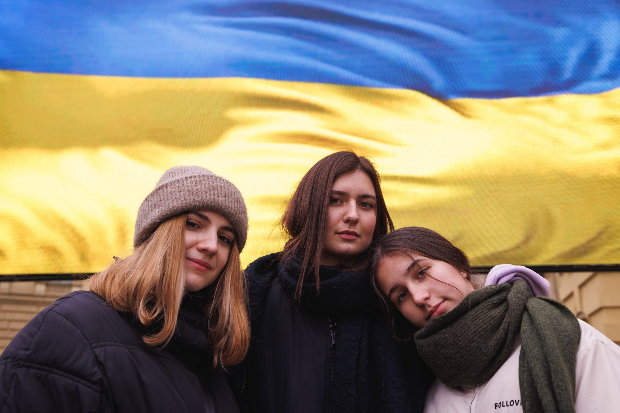 Petryšyn sisters in front of a Ukrainian flag, Berlin, 2022
