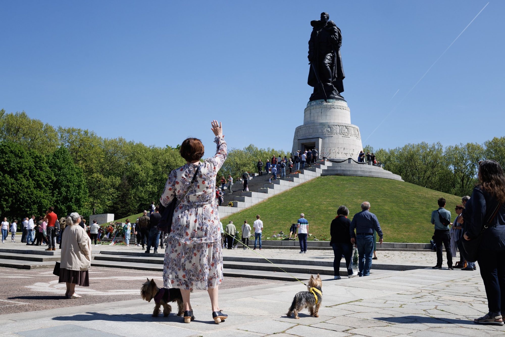 A woman raises her hand at the Soviet War Memorial at Treptower Park during Victory Day commemorations, Berlin, May 2022. Following Russia's invasion of Ukraine, the annual gathering has since been banned by Berlin authorities.